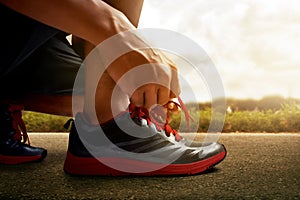 Man tying running shoes