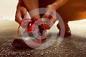 Man tying running shoes