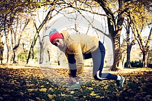 Man tying shoes before running.