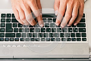 Man typing computer keyboard