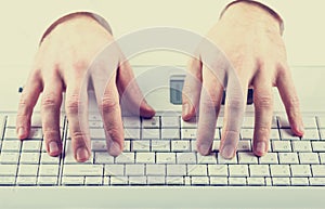 Man typing on a computer keyboard