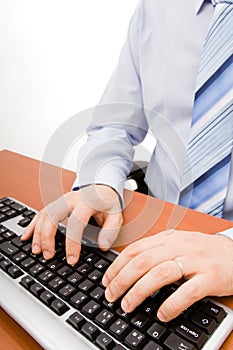 Man typing in the computer keyboard