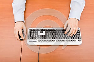 Man typing in the computer keyboard