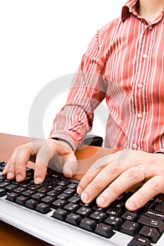 Man typing in the computer keyboard