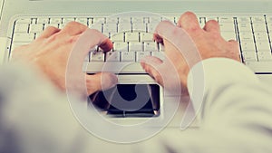Man typing on a computer keyboard