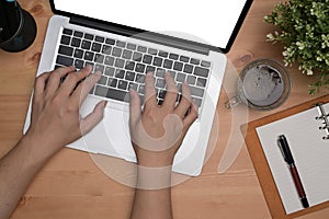 Man typing on keyboard of laptop computer.