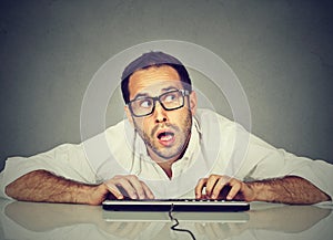 Man typing on keyboard wondering about reply photo