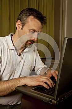 Man typing on a laptop