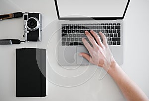 Man typing on laptop from above