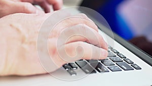 Man typing on laptop closeup