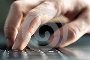 Man typing on a laptop computer