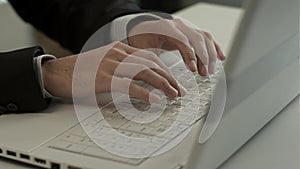 Man typing on laptop computer keyboard