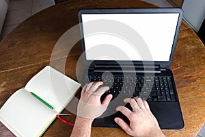 Man typing on a laptop computer in vintage kitchen