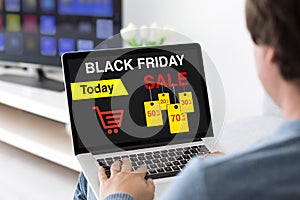 Man typing on laptop keyboard with sale black friday screen