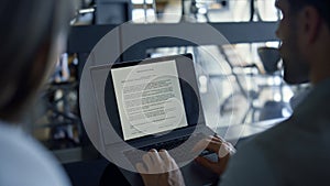 Man typing laptop screen with text office closeup. Coworkers signing contract