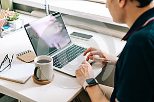 man typing on mockup laptop