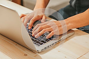 Man Typing on a Modern Laptop