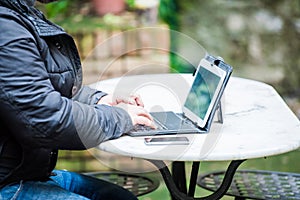 Man typing on a tablet