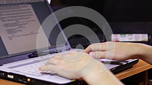 Man Typing Text on Computer Laptop on Wooden Desk