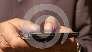 A man typing on a touch screen smartphone