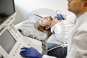 Man during an ultrasound diagnosis of the carotid artery