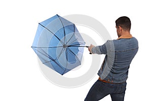 Man with umbrella caught in gust of wind on white background