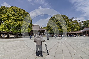 Man with umbrella in Meiji Shrine in Tokyo, Japan