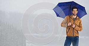 Man with umbrella over bright icy lake