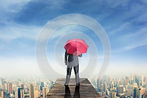 Man with umbrella standind on the pier