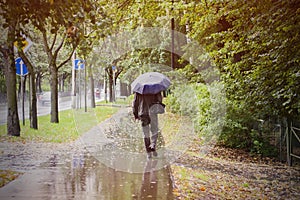 Man with umbrella walking outoor
