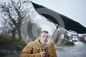 Man with umbrella in wind and rain