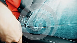 Man unbuckles or unfastens his seat belt, close-up shot