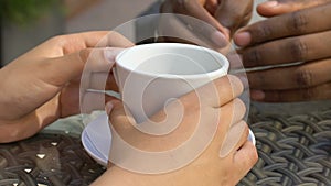 Man uncertainly stroking woman hands, meeting in cafe, first love, closeup