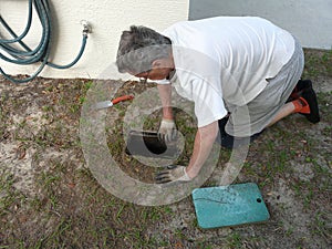 Man Uncovering Water Stop Valve