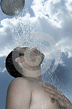 Man under outdoor shower