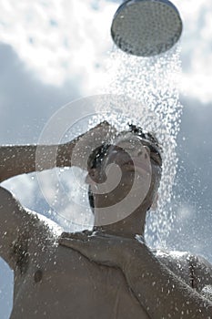 Man under outdoor shower