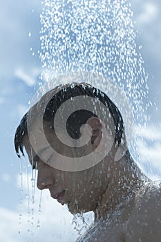 Man under outdoor shower