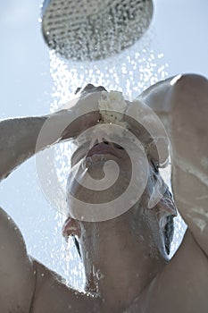 Man under outdoor shower