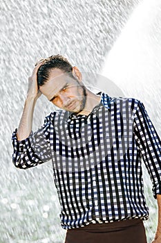 Man under rain upset wet water shower sun summer sad lonely disappointed lonliness courageous lover cleansing look deadpen