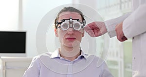 Man undergoes examination with optical trial lens frame