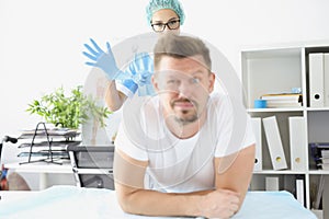 Man undergoes medical examination at proctologist office photo
