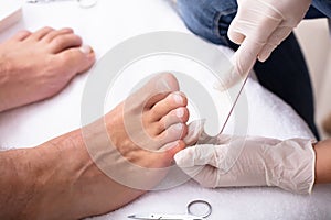 Man Undergoing Pedicure Process In Salon