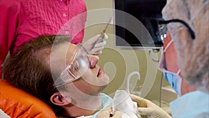 Man undergoing teeth polishing in dental clinic