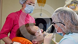 Man undergoing teeth polishing in dental clinic