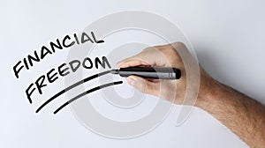 Man underlining words Financial Freedom on white background, top view