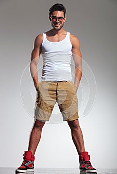 Man in undershirt and shorts smiling