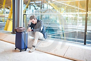 Man unhappy and frustrated at the airport his flight is cancelled