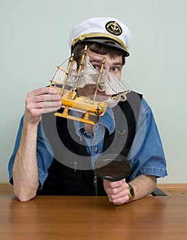 Man in uniform cap with sailer photo