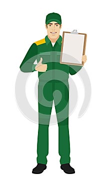 Man in uniform holding clipboard and shows thumb up
