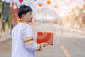 Man university graduates in graduation gown with diploma